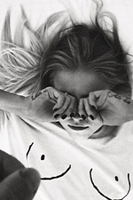 Iconic white organic cotton Boob T-shirt with black line art worn by a model lying down.