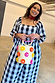 Black and white Gingham Macy Midi Dress with ruffled sleeves, pink rickrack trim, and a colourful pom-pom straw bag.