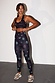 Peace Athleisure Crop Top and matching leggings featuring a colourful peace, heart, and star print on a model.