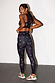 Peace print athleisure crop top and leggings with neon symbols, shown on a model from behind.