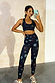 Peace Athleisure Crop Top and matching leggings with a colourful peace, heart and star print on a model taking a selfie.