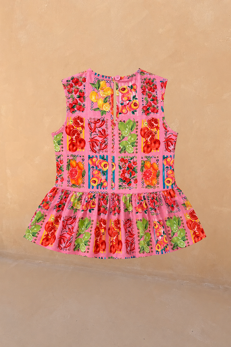 NFD Kids Pink Fruit Peplum Top with a Mediterranean fruit print, sleeveless cotton and back button detail.