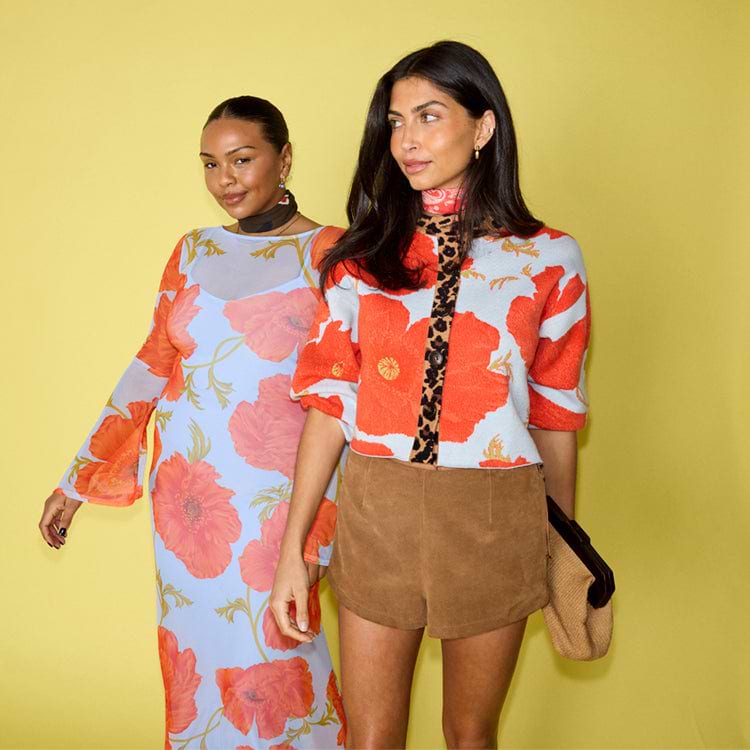 Blue Poppy Cardigan in pale blue with orange poppy print and leopard trim, shown on two models for inclusive sizing.