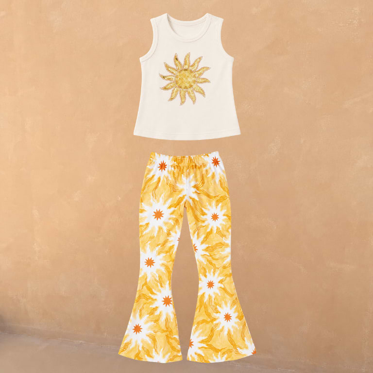 Cream cotton vest with a sequin sun and matching flared trousers in a yellow soleil print.