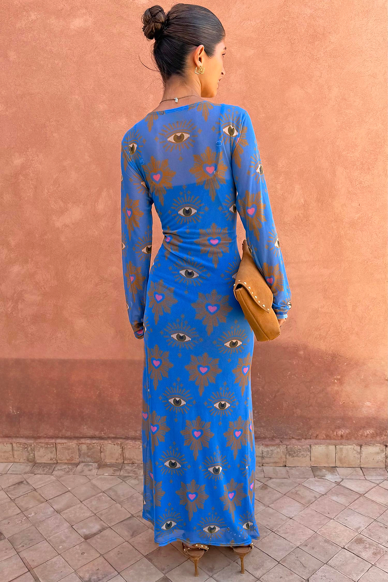 Blue Eye Mesh Maxi Dress with heart and eye motifs and long sleeves, shown from the back on a model.