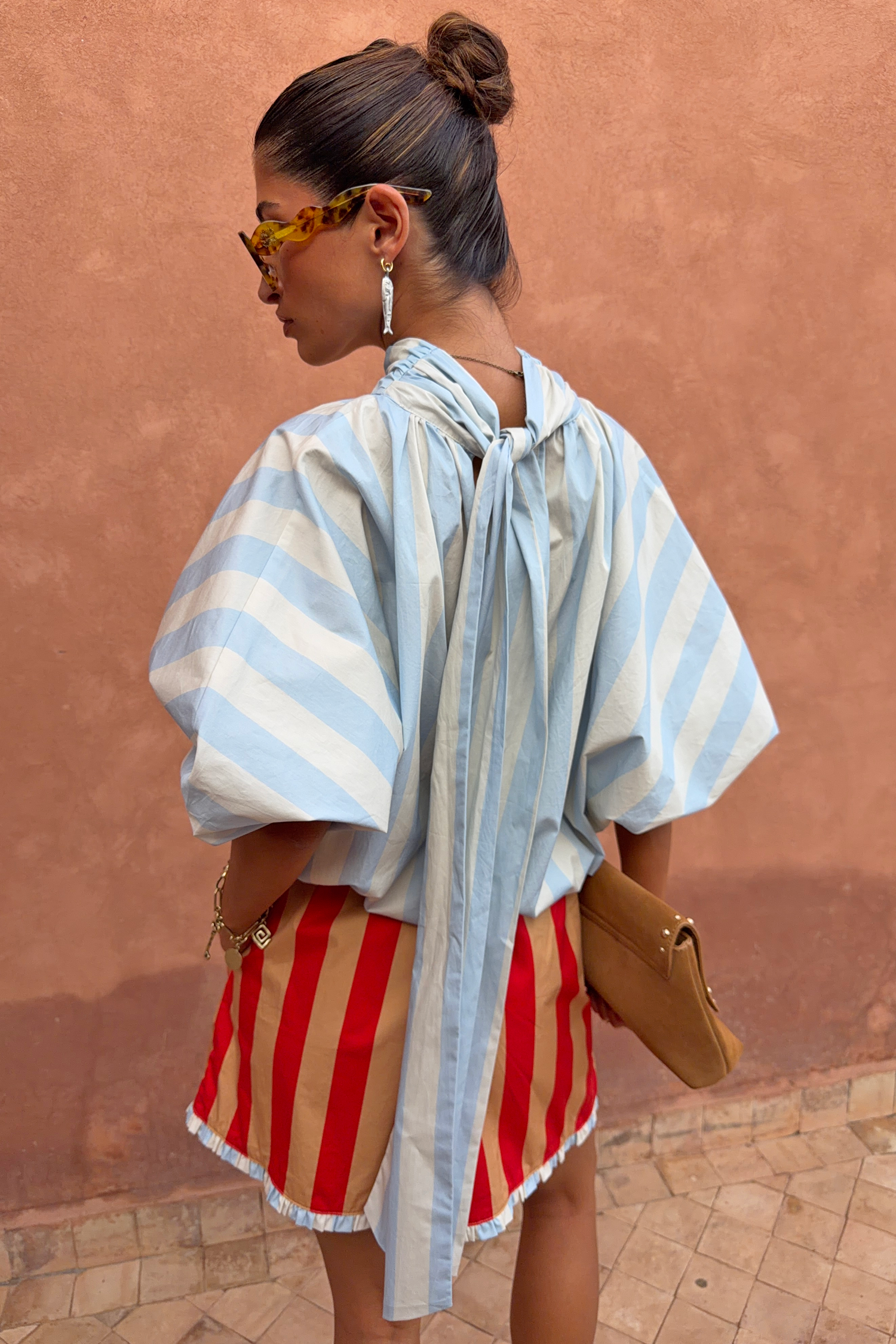 Blue Stripe Batwing Blouse featuring voluminous sleeves and a long back tie detail, shown from a back view.