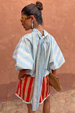 Blue Stripe Batwing Blouse featuring voluminous sleeves and a long back tie detail, shown from a back view.