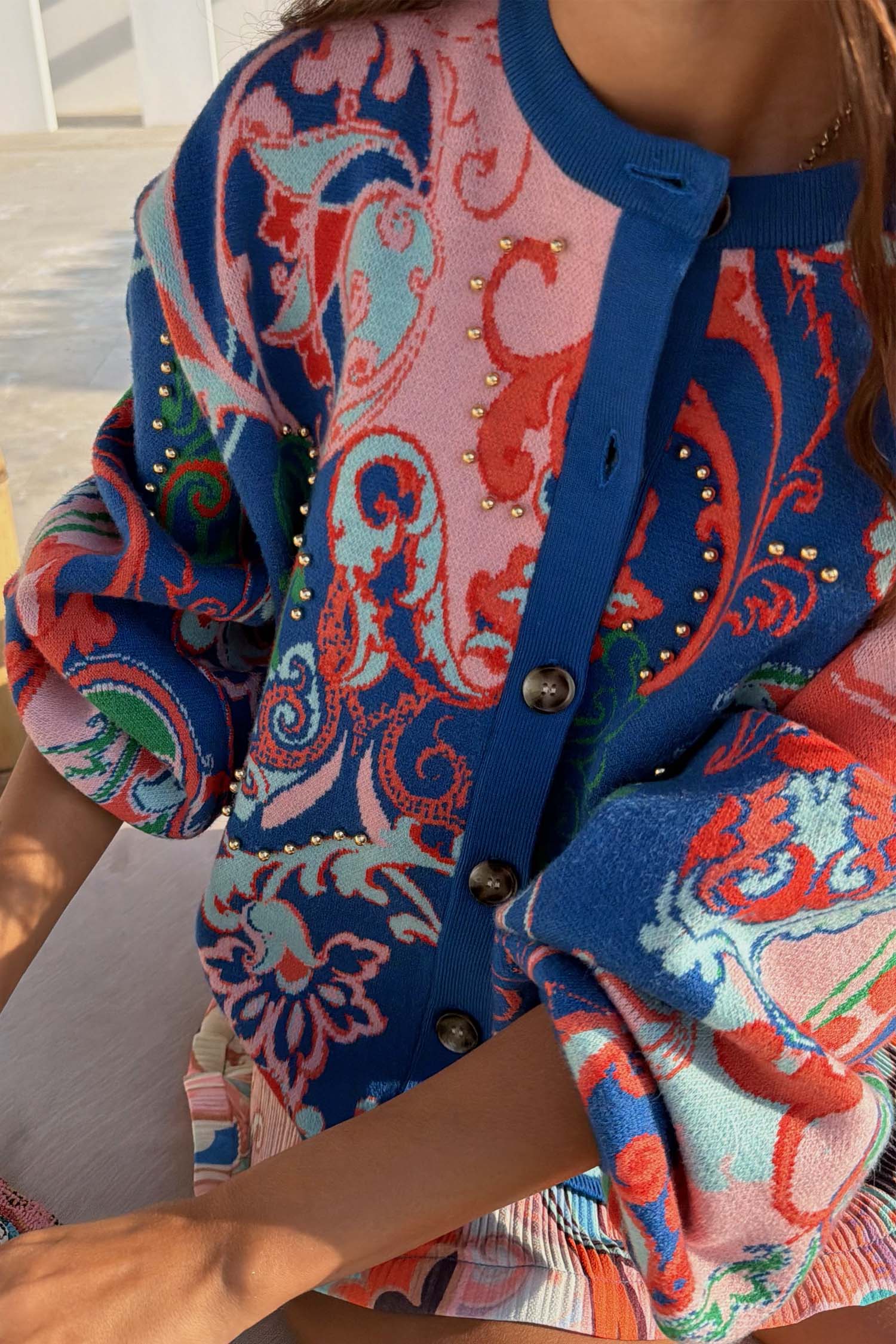 Blue Mari Cardigan in a vibrant paisley knit with gold stud accents and front button fastening.