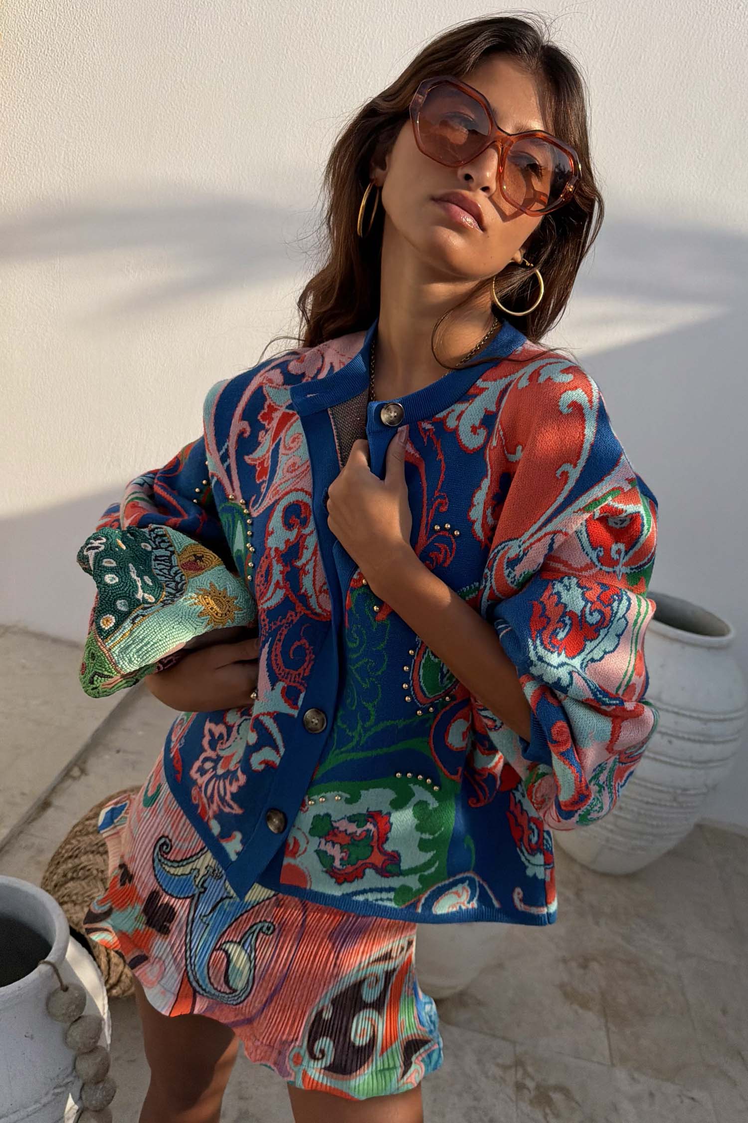 Blue Mari Cardigan featuring a deep blue paisley print with orange and turquoise tones and a button-up front.
