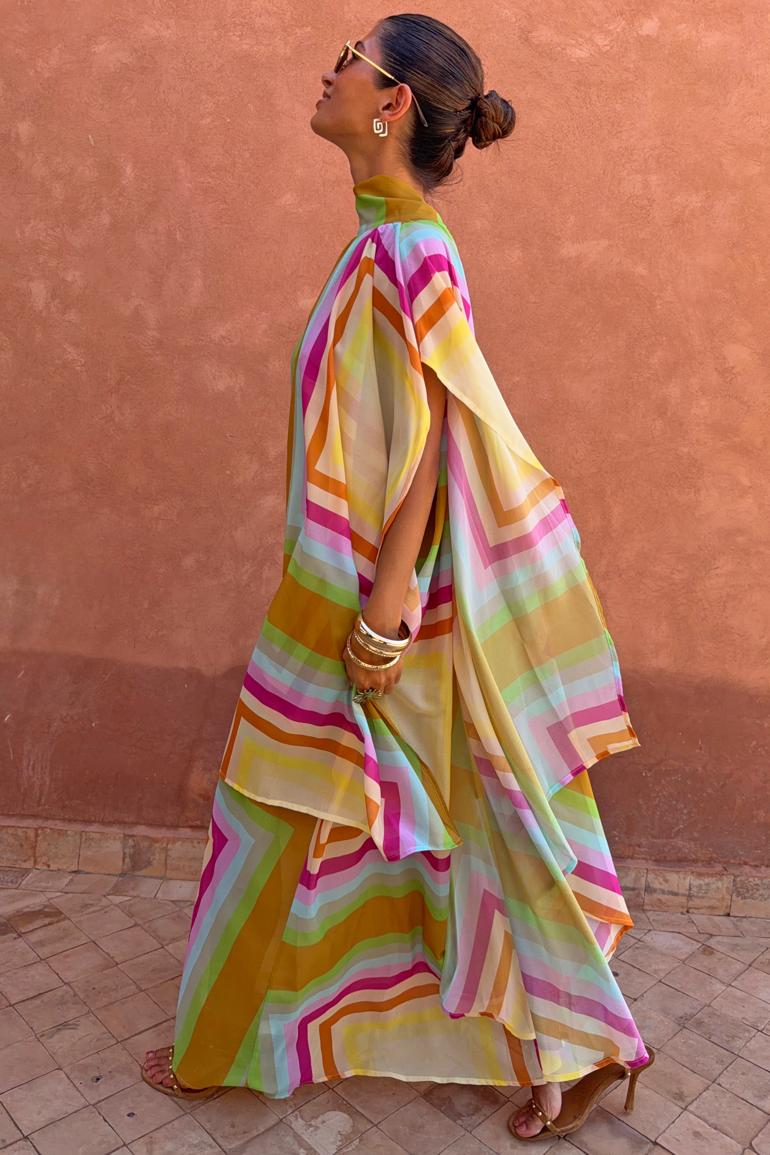 Bright Geo Stevie Maxi Dress with a colourful geometric print and cape sleeves, shown in a side profile.