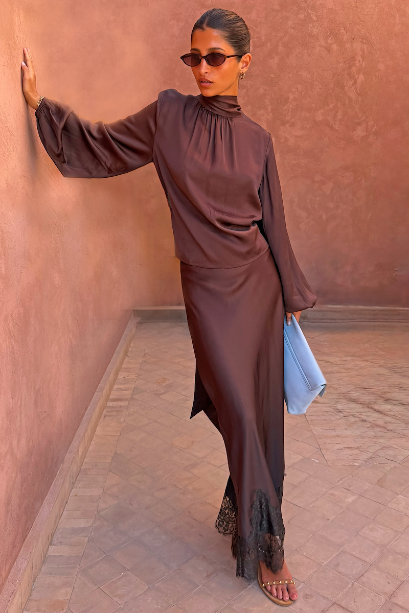 Chocolate Maeva Skirt with black lace border and matching tie-neck blouse, a transeasonal co-ord for day to night styling.