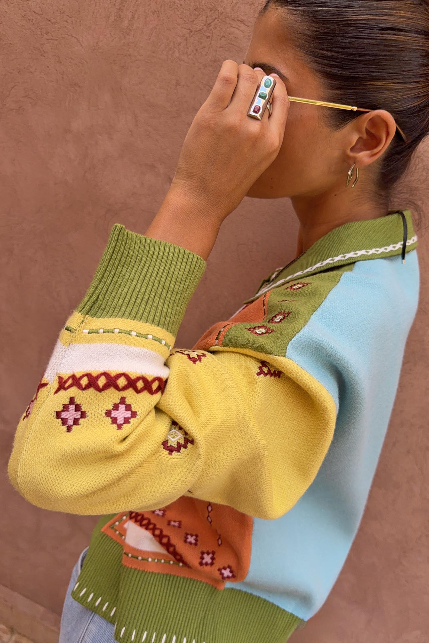 Green Geometric Palm Cardigan in a colourful jacquard knit with palm motifs and white blanket stitch detail.