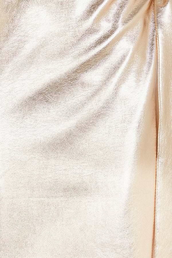 Close-up of the textured metallic gold vegan leather fabric on the iconic Jaspre wrap skirt.