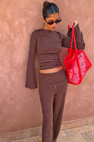 Fold Over Pants in Chocolate Stripe and matching long sleeve top in ribbed fabric, styled with a red mesh bag.