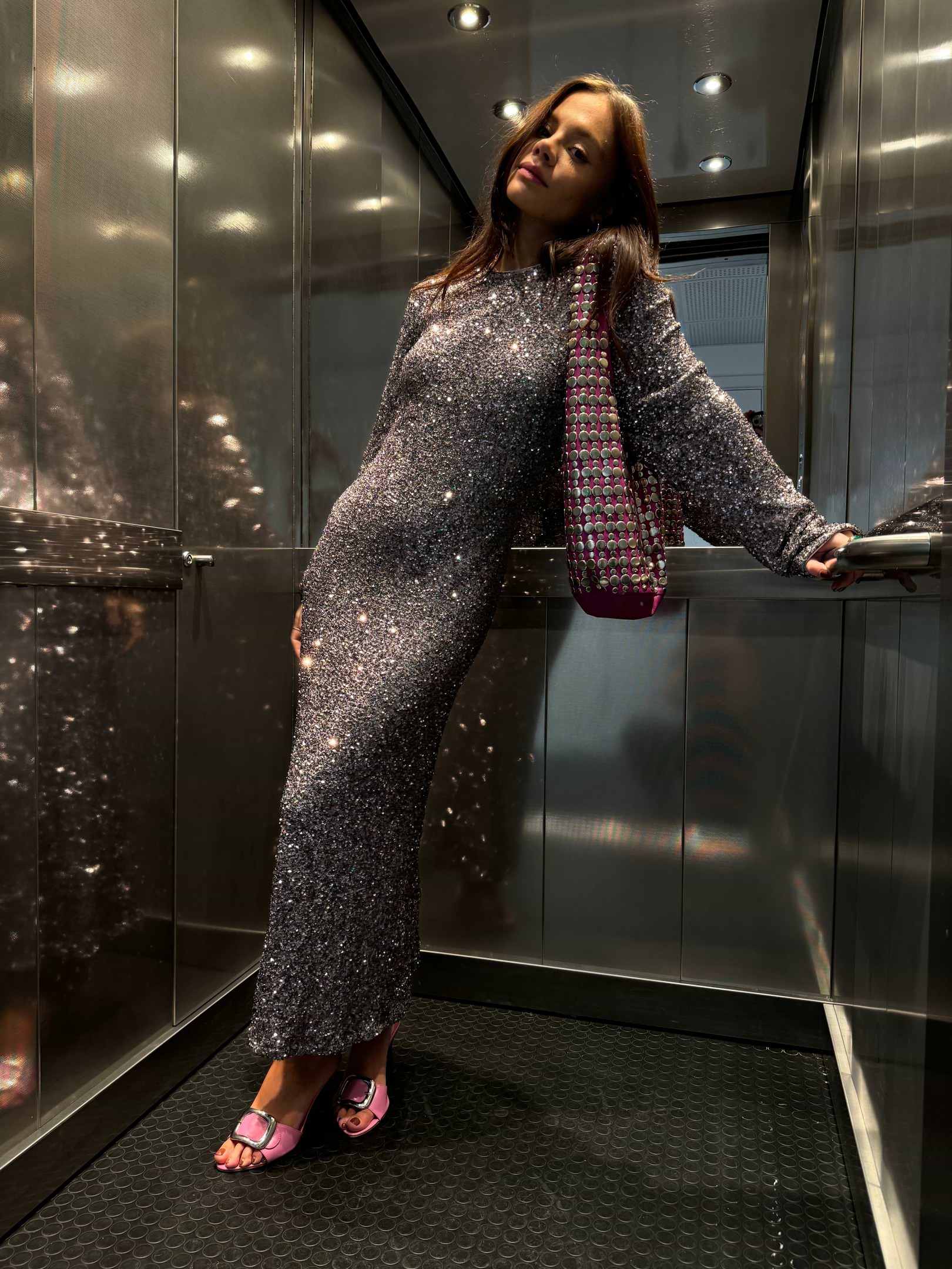 Gunmetal Sequin Soho Dress with a body-skimming fit and long sleeves, worn by a size 8, 5ft5” model in a lift.