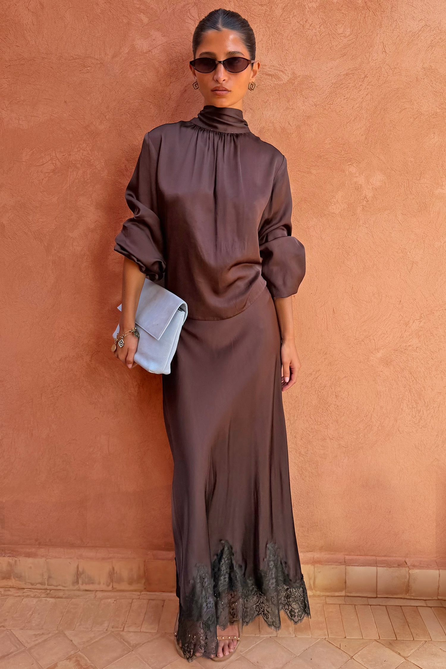 Chocolate Maeva Skirt, a bias-cut chocolate brown wardrobe staple with a black lace border at the hem.