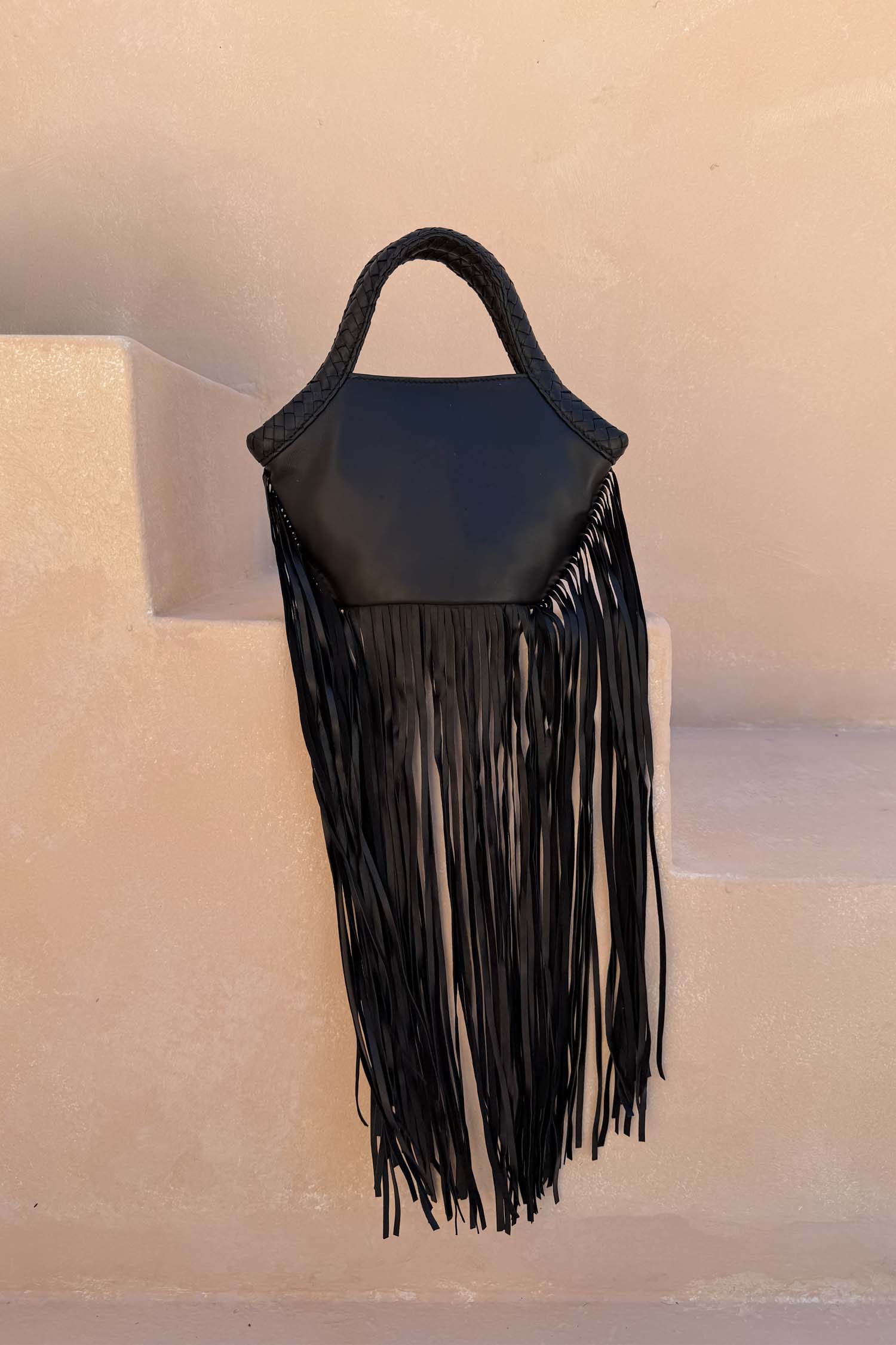 Black Leather Fringe Bag with a plaited handle and long fringe, a versatile statement staple.