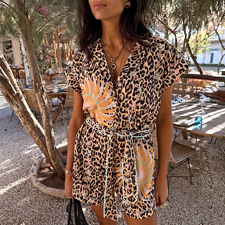 Leopard and soleil print playsuit featuring turquoise trim, a button-through front and adjustable tie waist on a model.