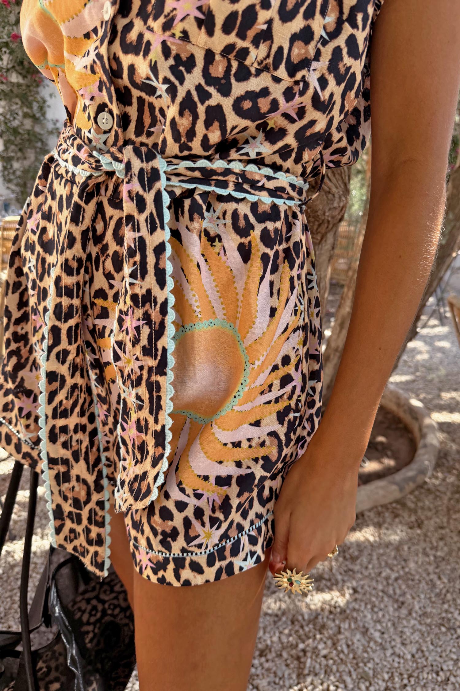 Leopard Print Playsuit featuring a soleil sun print, contrast turquoise trim and a matching waist tie.