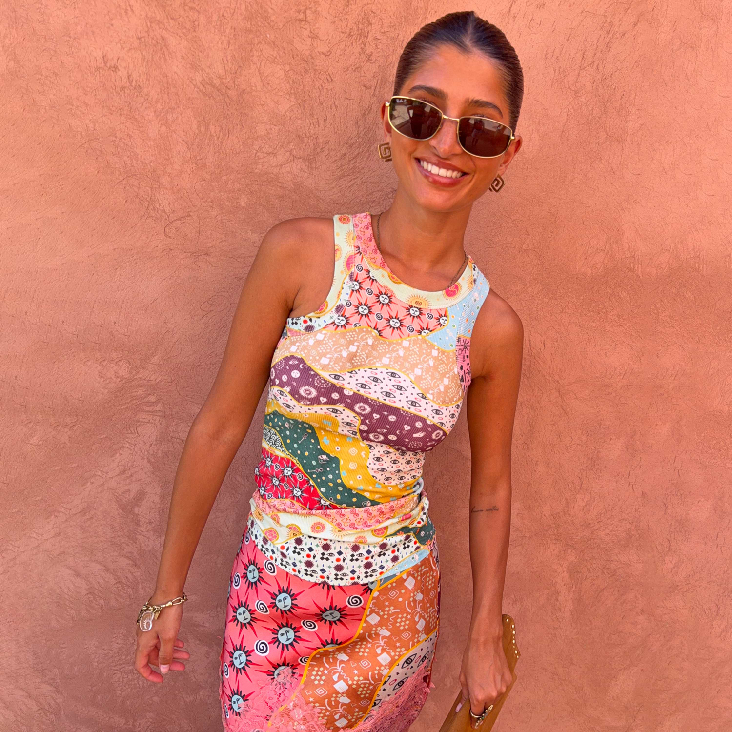 Pastel Morocco Rib Tank Top with abstract sun and eye motifs in a soft ribbed fabric, styled on a model outdoors.