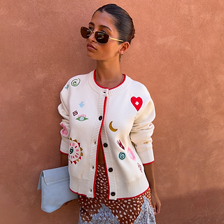 Morocco Charms Cheryl Cardigan in cream with red trim and colourful embroidered motifs, styled on a model.