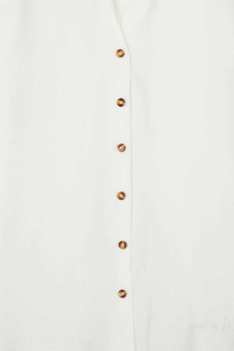 White Miley Shirt featuring contrast tortoise buttons on lightweight, slightly sheer fabric.
