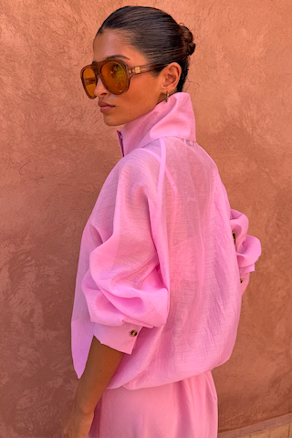 NFD Pink Organza Funnel Jacket in sheer fabric with a statement high collar, shown in profile on a model.