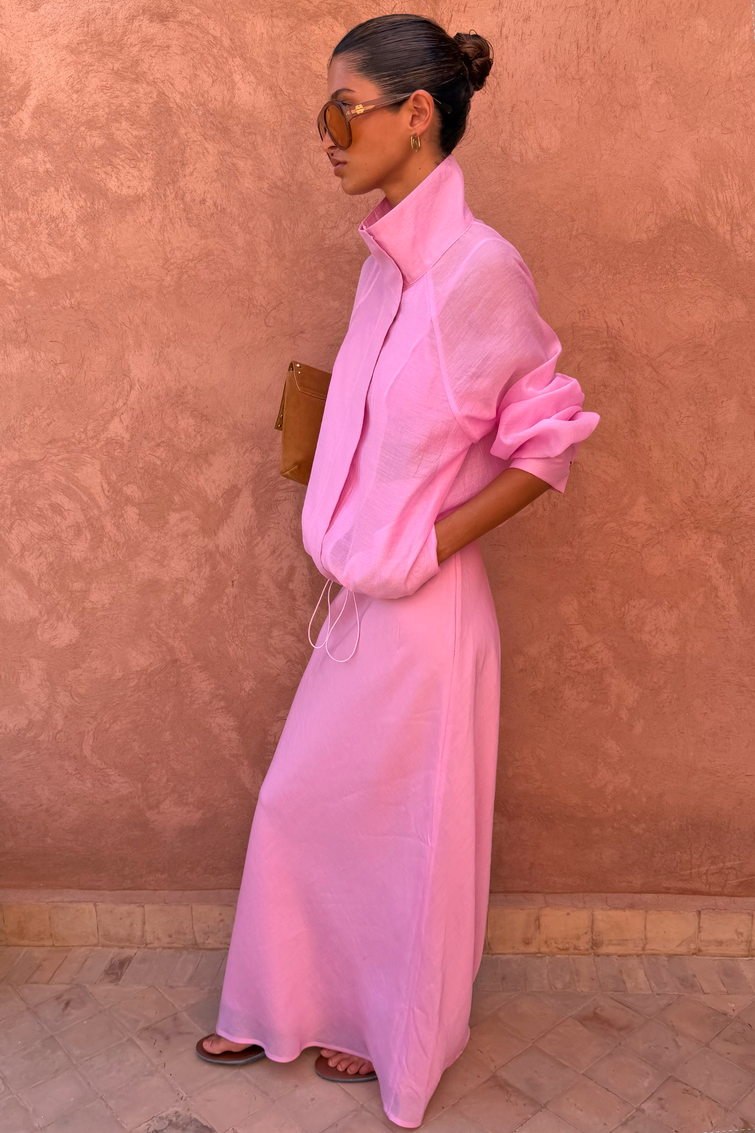 Sheer Pink Organza Funnel Jacket and matching maxi skirt styled against a textured terracotta wall.