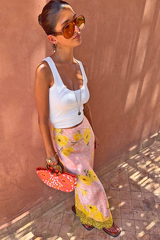 Pink Fawn Poppy Maeva Petite Midi Skirt featuring yellow floral motifs and a contrast lace hem.
