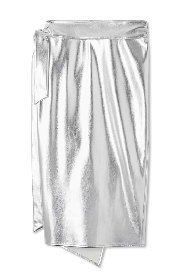 Silver metallic vegan leather Jaspre wrap midi skirt with a side tie detail on a white background.