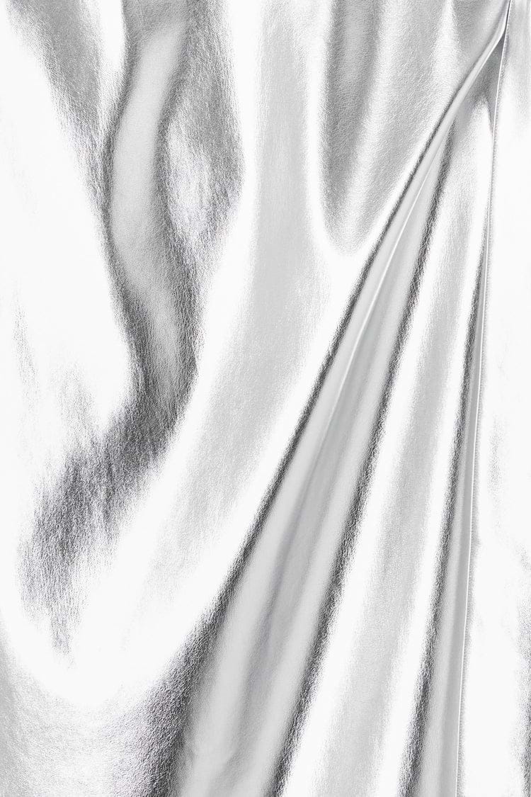 Close-up of metallic silver vegan leather fabric on the iconic Jaspre wrap skirt.