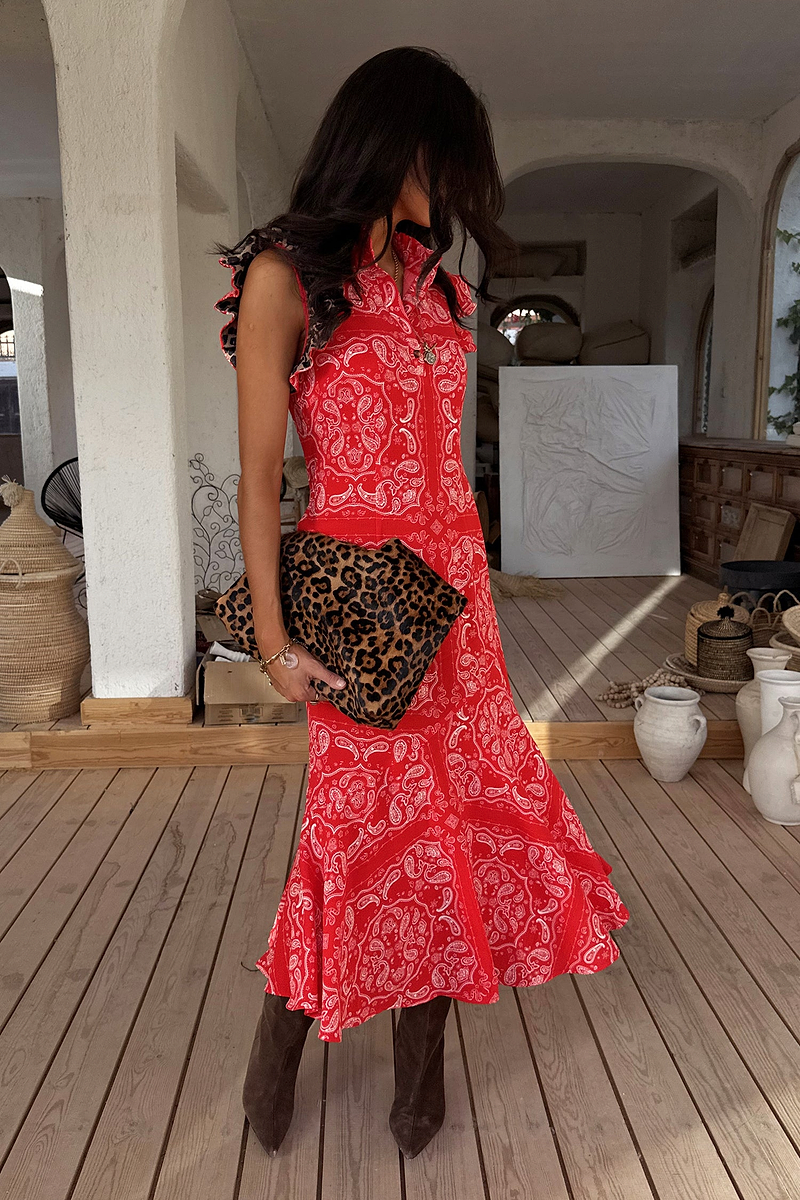Red Bandana Remi Dress featuring leopard print sleeves and an asymmetrical frill hem, styled with a leopard clutch.