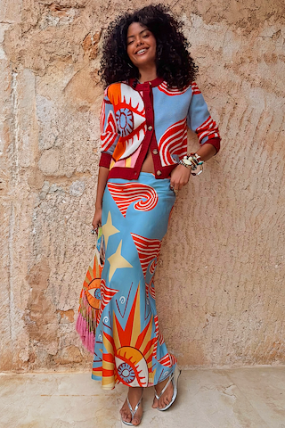 Petite Dolce Vita Dorris Skirt in a blue satin-feel bias cut with sun motifs and a matching Hollie cardigan.