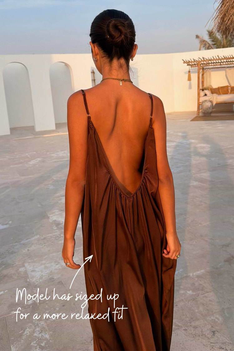 Chocolate Balloon Jumpsuit featuring a deep V-back and slim straps, shown in a relaxed fit on a model.