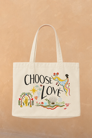 Choose Love Tote Bag in cream recycled cotton featuring colourful graphic artwork and black text against a tan wall.