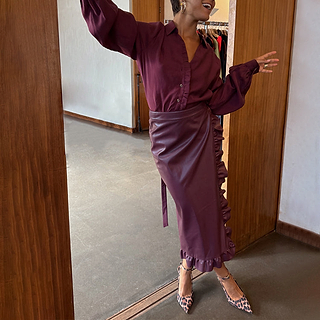 Burgundy Vegan Leather Ruffle Jaspre wrap midi skirt styled with a matching shirt and leopard print heels.