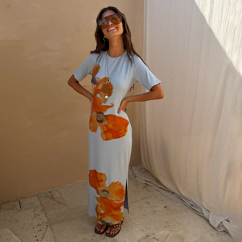 Ice Blue Floral Rib Dress with a bold orange floral print, short sleeves and a side slit on a model.