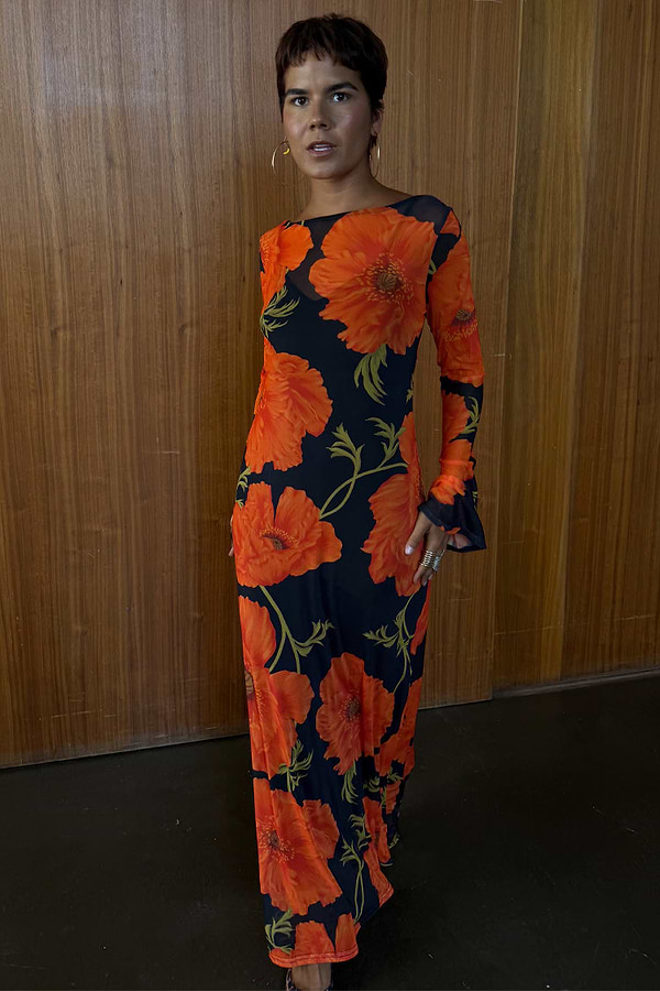 Black Poppy Aria Mesh Dress with red poppy print, long sleeves and sheer fabric shown on a model.