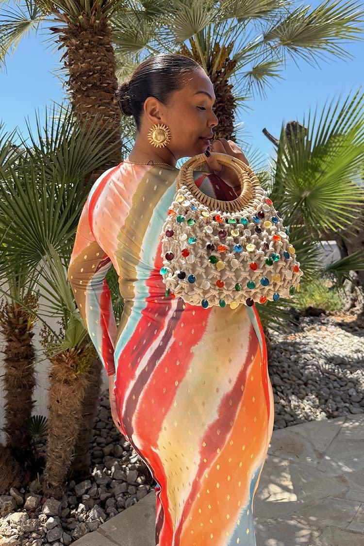 Sunset Stripe Mesh Midi Dress in multicoloured mesh, styled with a beaded bag and sun earrings.
