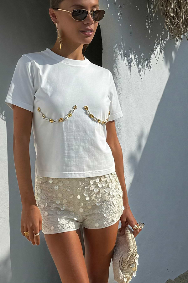 Cream Shells Hot Pants with pearlescent shell beads and glass beading, styled for a summer vacation look.