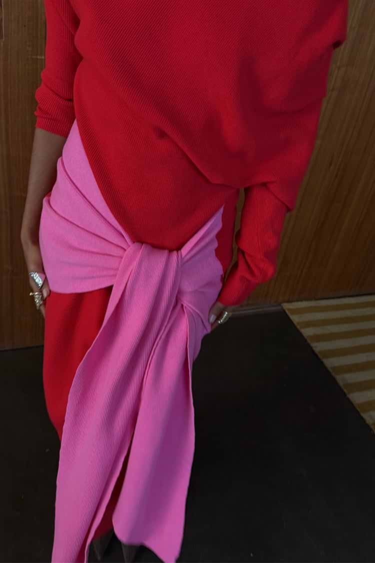 Red and Pink Afia Midi Dress in a soft knit, highlighting the contrast pink multi-wear wrap tie detail.