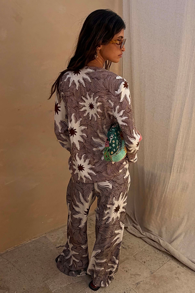 Ribbed Chocolate Soleil Alexa Cardigan in a brown sun print, styled as a co-ord with matching trousers.