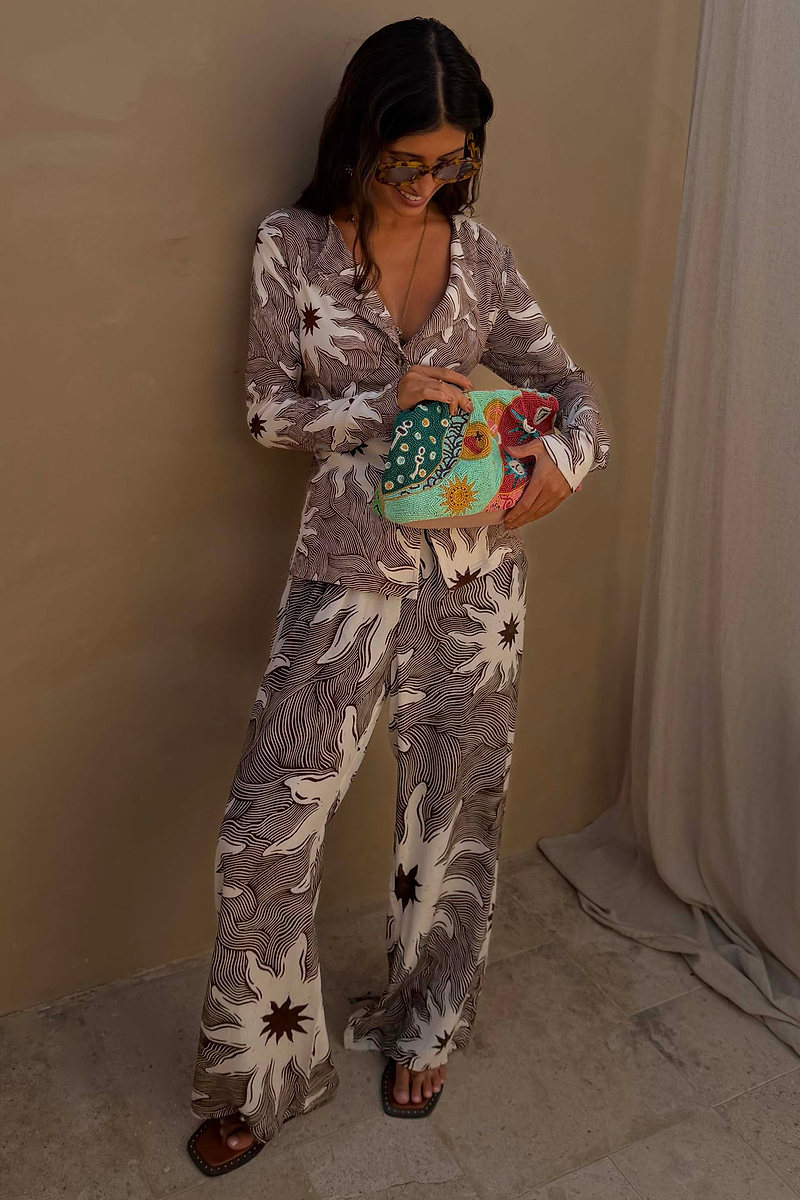 Chocolate Soleil Ellie Trousers and Alex Cardigan co-ord featuring a sun motif print and line detailing.