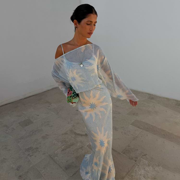Blue Soleil Anais Dress featuring a Mediterranean soleil sun print, sheer draped top and satin-esque maxi skirt.