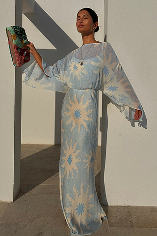 Blue Soleil Anais Dress with Mediterranean sun motifs, a sheer draped top and a flowing satin-esque maxi skirt.