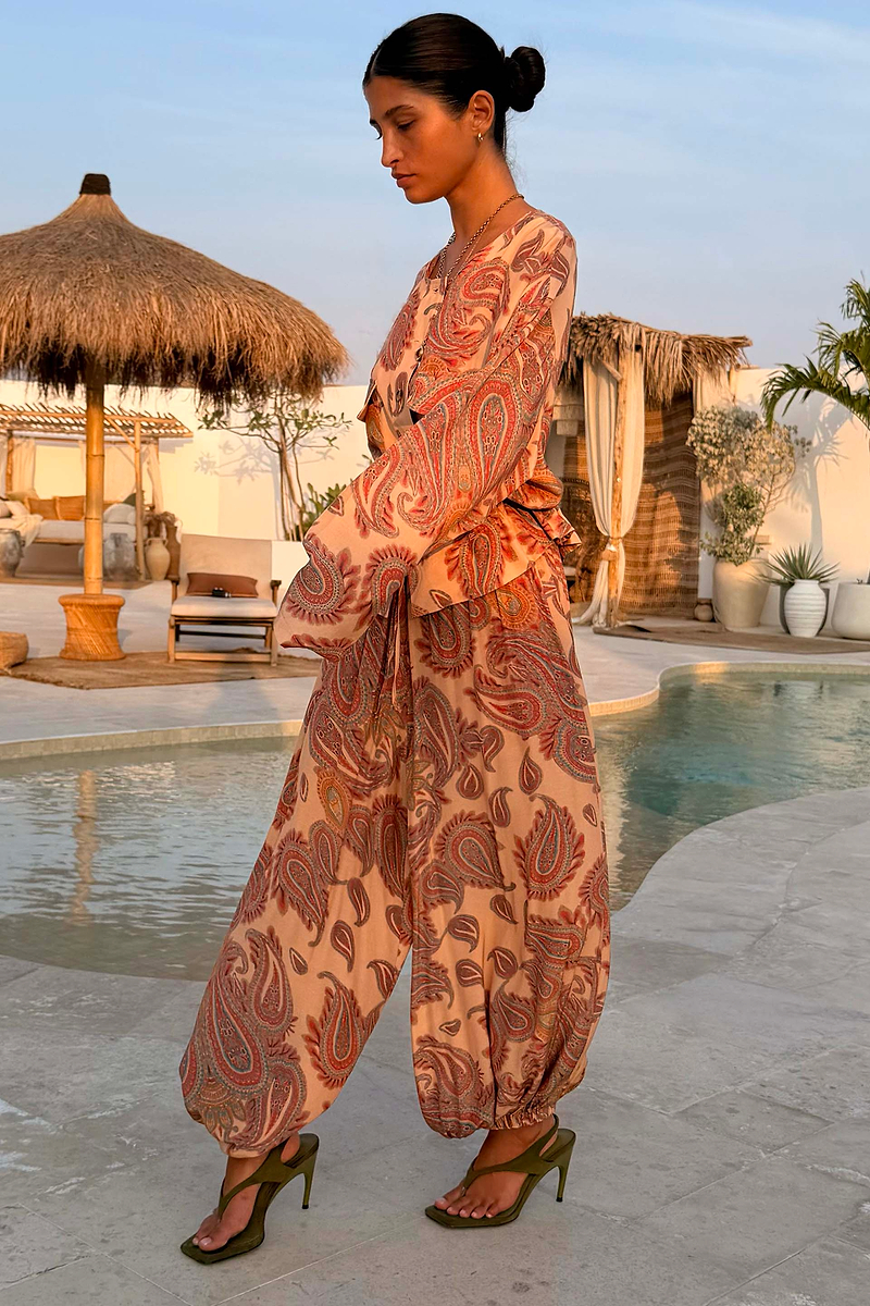 Peach Paisley Balloon Trousers and matching top styled as a co-ord in a poolside vacation setting.