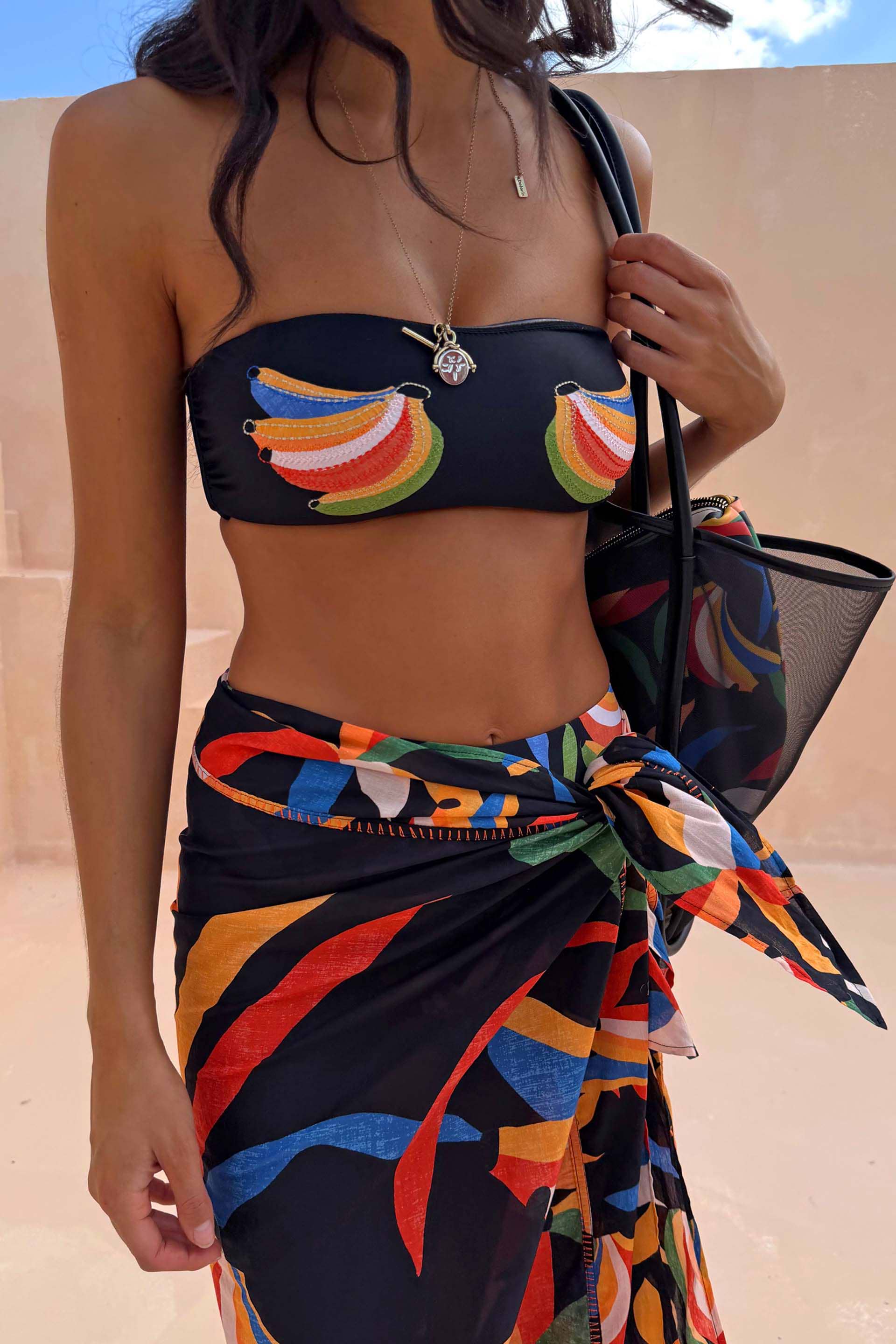 Banana Bandeau Bikini Top in black with colourful embroidered banana motifs and a coordinated multi-wear wrap sarong.