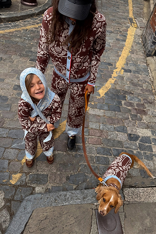 Chocolate Bandana Dog Jumper on a pup, styled with matching family knitwear on a cobbled London street.