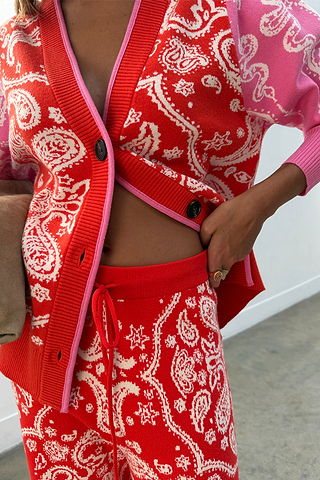 Red Bandana Martha Cardigan in a soft knit with pink trim, paired with matching red and pink joggers.