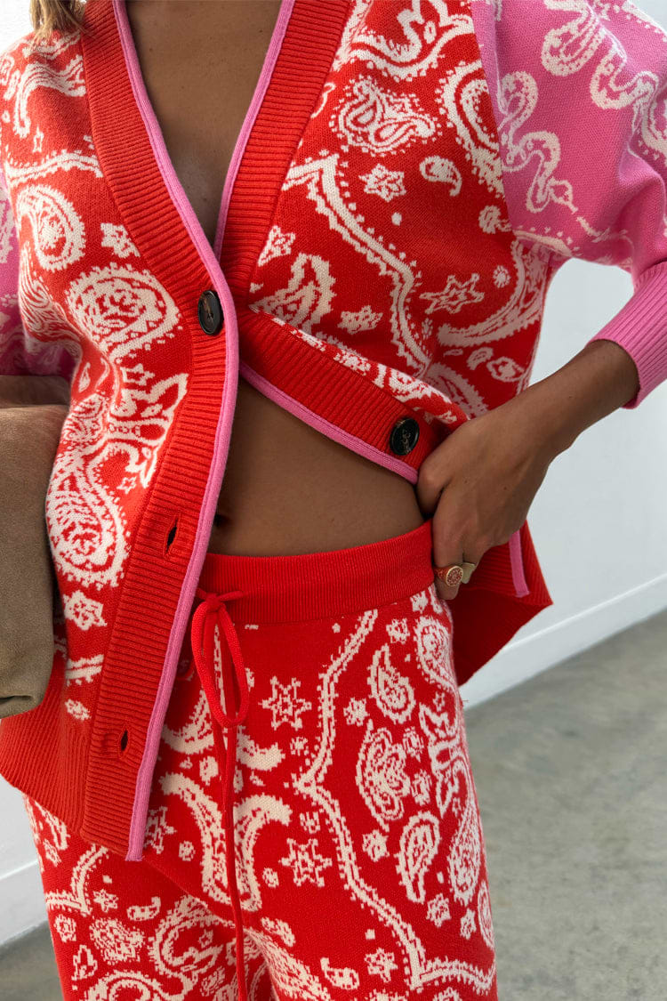 Red Bandana Martha Cardigan in a soft knit with pink trim, paired with matching red and pink joggers.